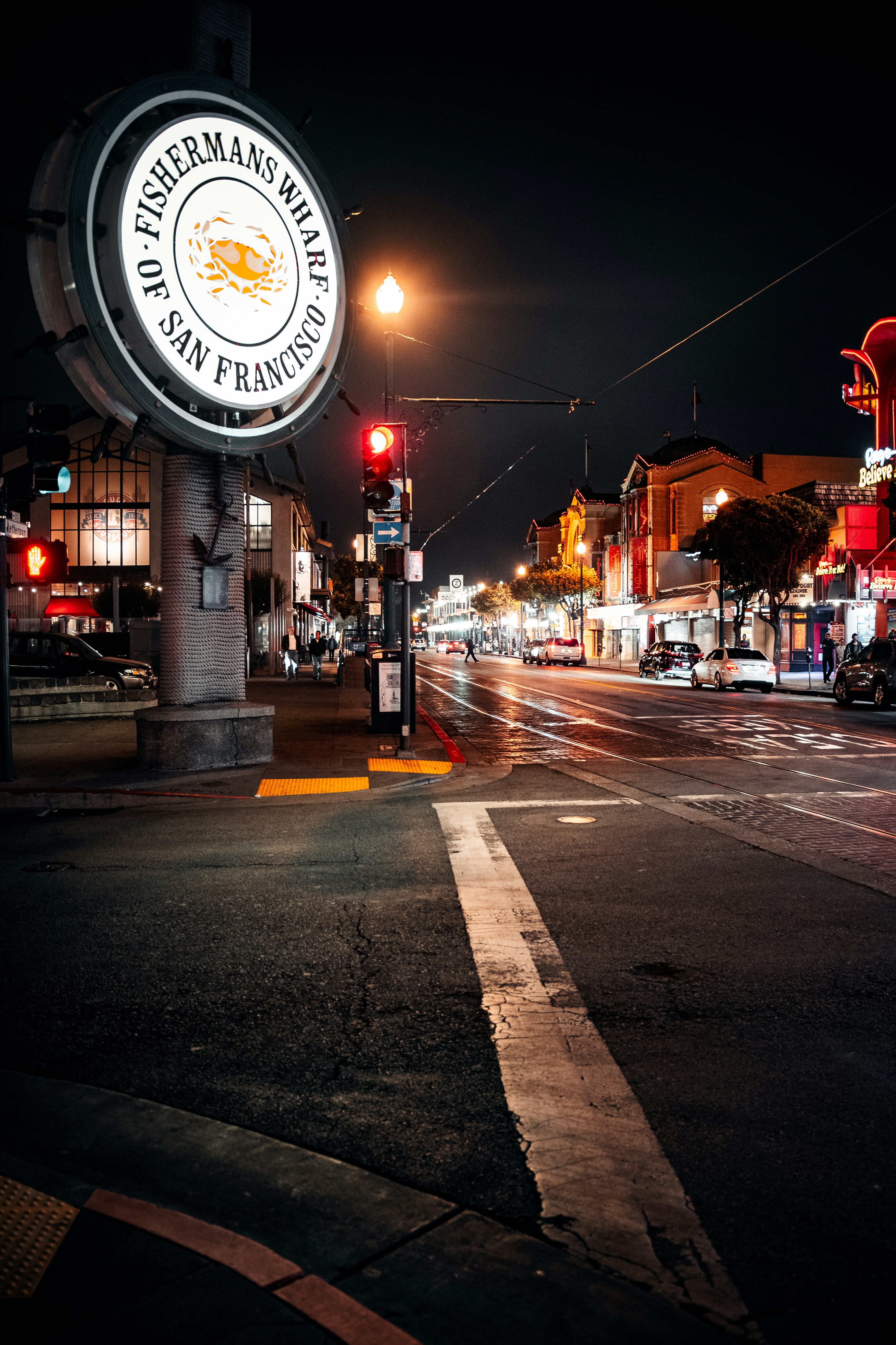 people walking on pedestrian lane during night time